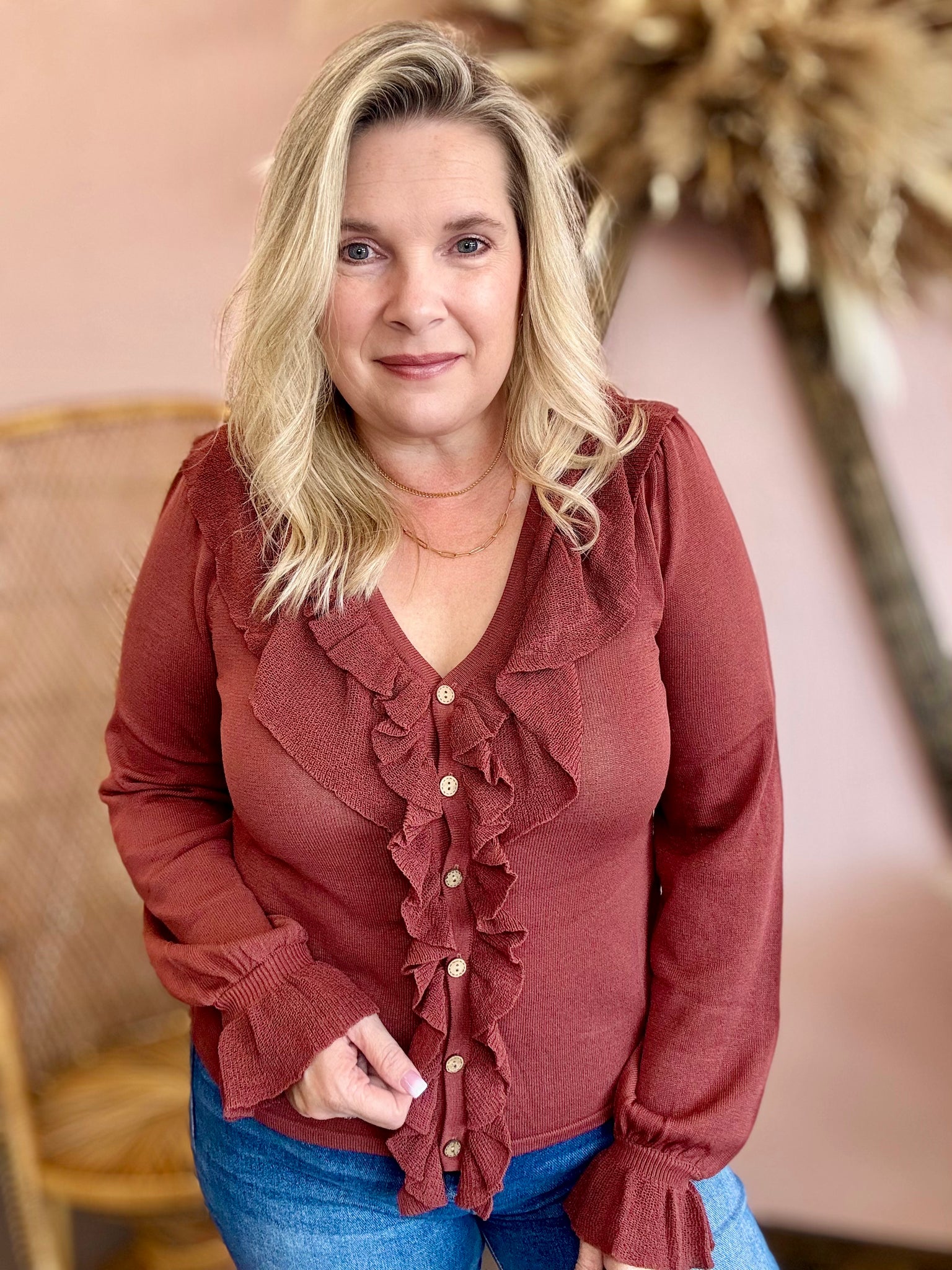 rust-colored blouse with ruffled details 