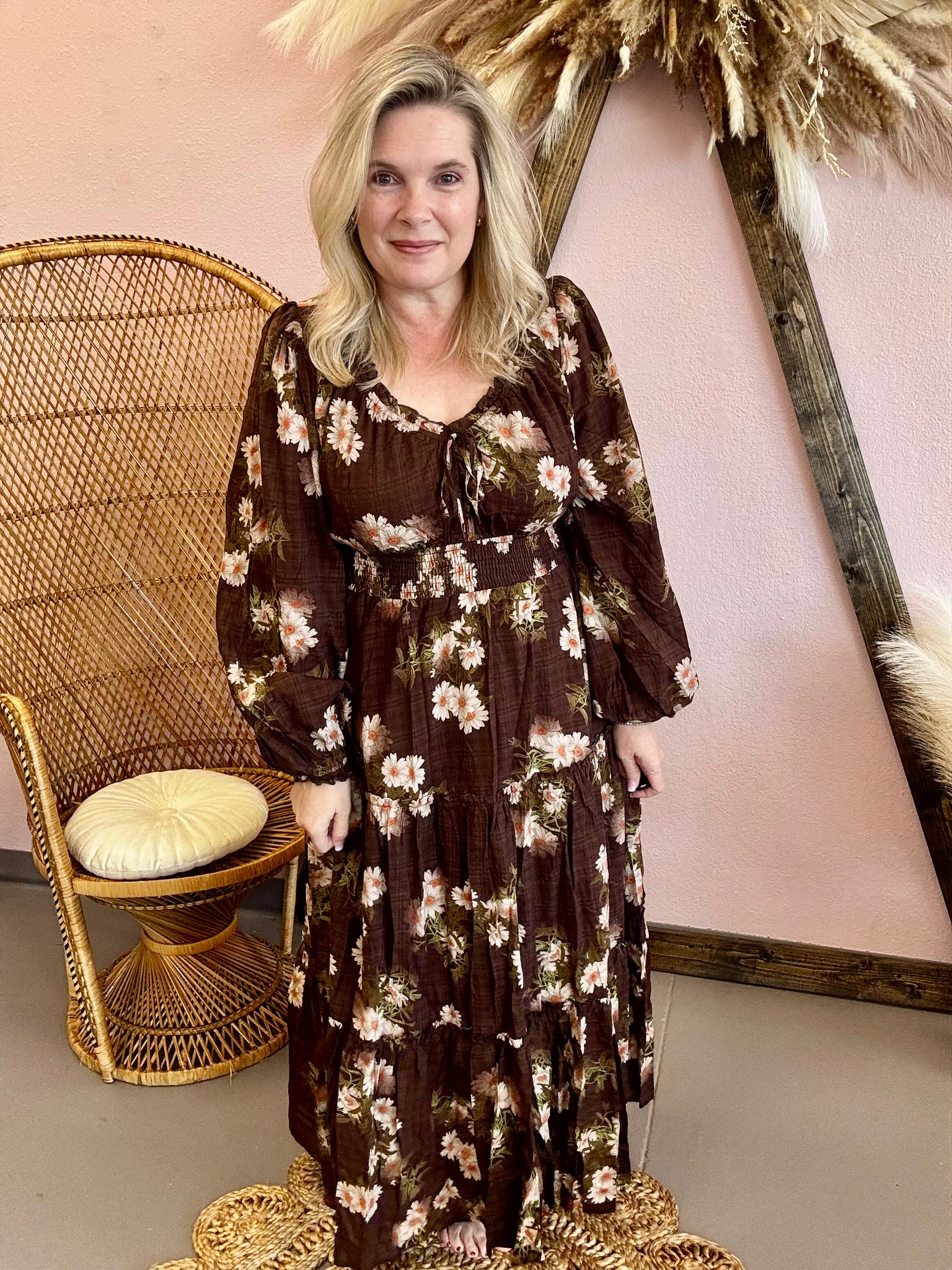 Woman wearing a long floral boho dress with ruffle details