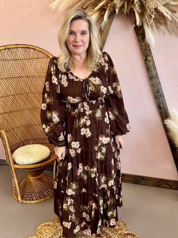 Woman wearing a long floral boho dress with ruffle details