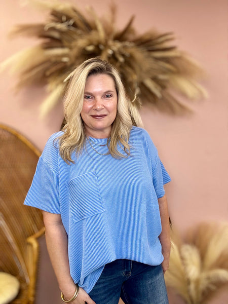 Women wearing blue ribbed top 