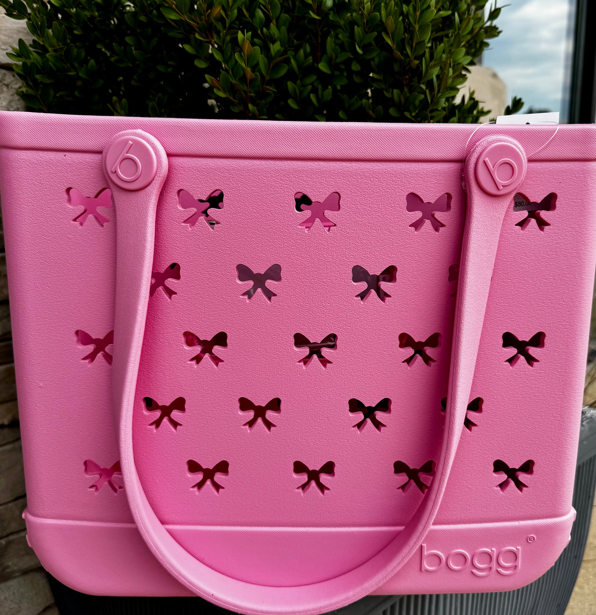 Pink reusable shopping bag with bow pattern and 'bogg' branding.