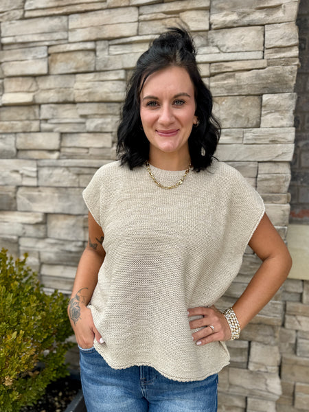Women's ivory lightweight knit sweater with short sleeves, relaxed oversized fit, crew neckline, and textured knit design.