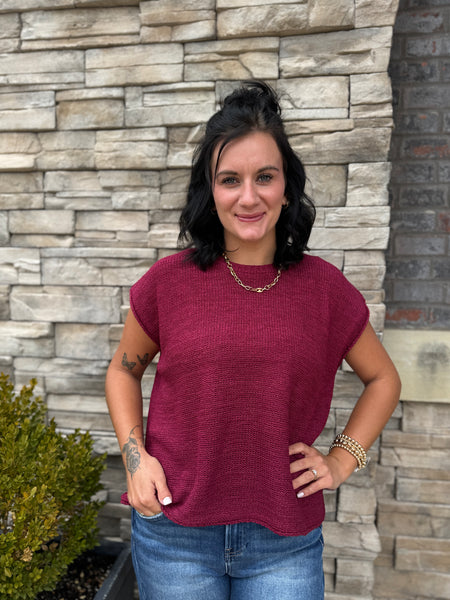 Women's burgundy lightweight knit sweater with short sleeves, relaxed oversized fit, crew neckline, and textured knit design.