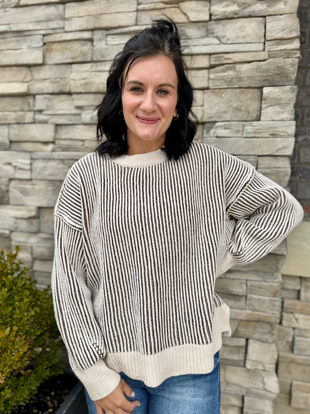 Women's ivory and brown striped knit sweater with long sleeves, crew neckline, ribbed trim, and relaxed fit.