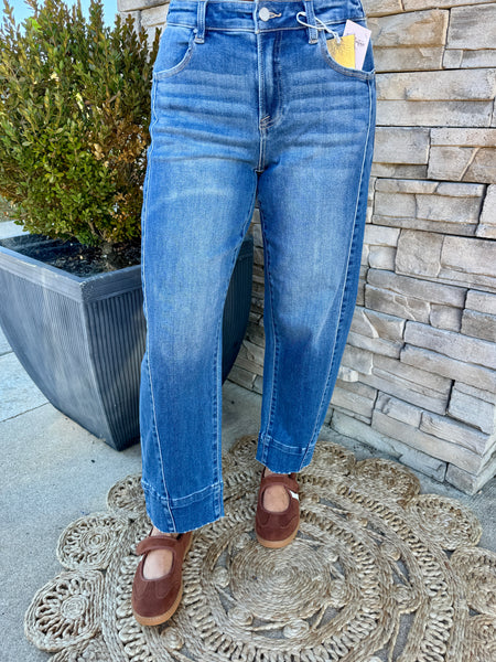 A person wearing medium-wash slouchy cropped barrel jeans