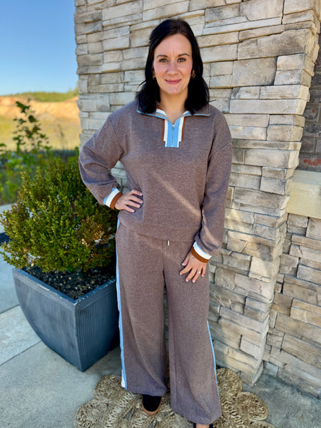 Women's taupe two-piece lounge set featuring a long sleeve sweatshirt with striped neckline and cuffs, matching sweatpants with multicolor side stripes, and a relaxed fit.