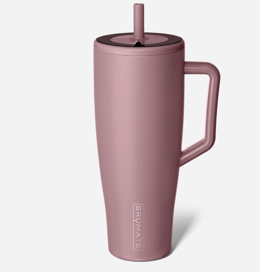 Pink insulated mug with handle and straw lid on a white background