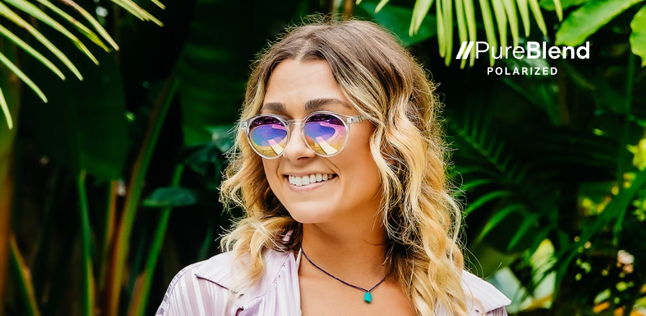 Woman wearing sunglasses with a tropical background and 'PureBlend Polarized' branding.