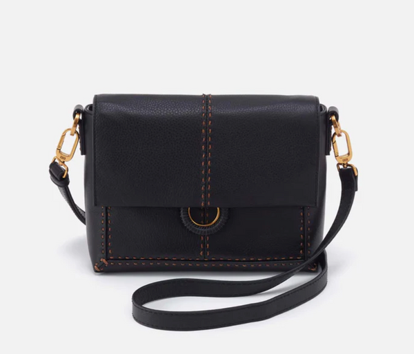 Black leather crossbody bag with gold accents on a white background