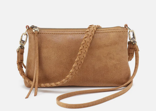Brown leather handbag with braided strap on a white background