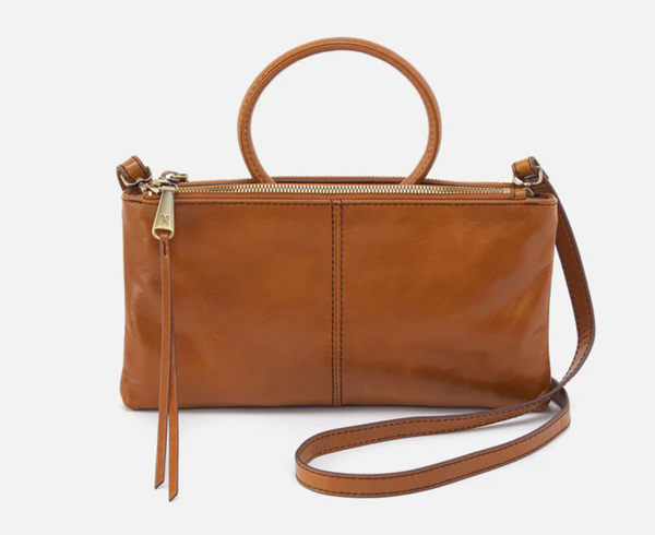 Brown leather handbag with a strap on a white background