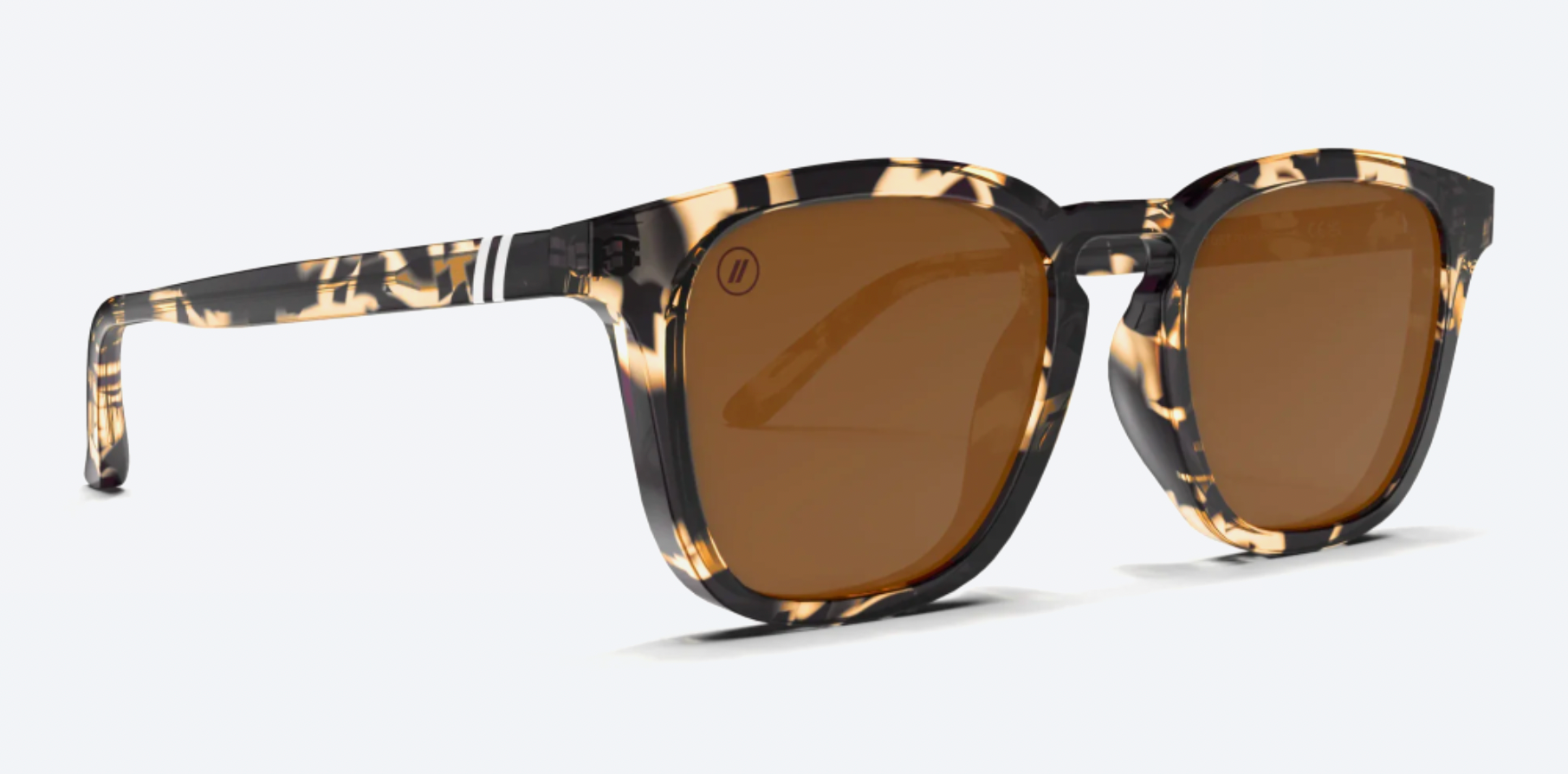 Sunglasses with tortoiseshell frame and brown lenses on a white background